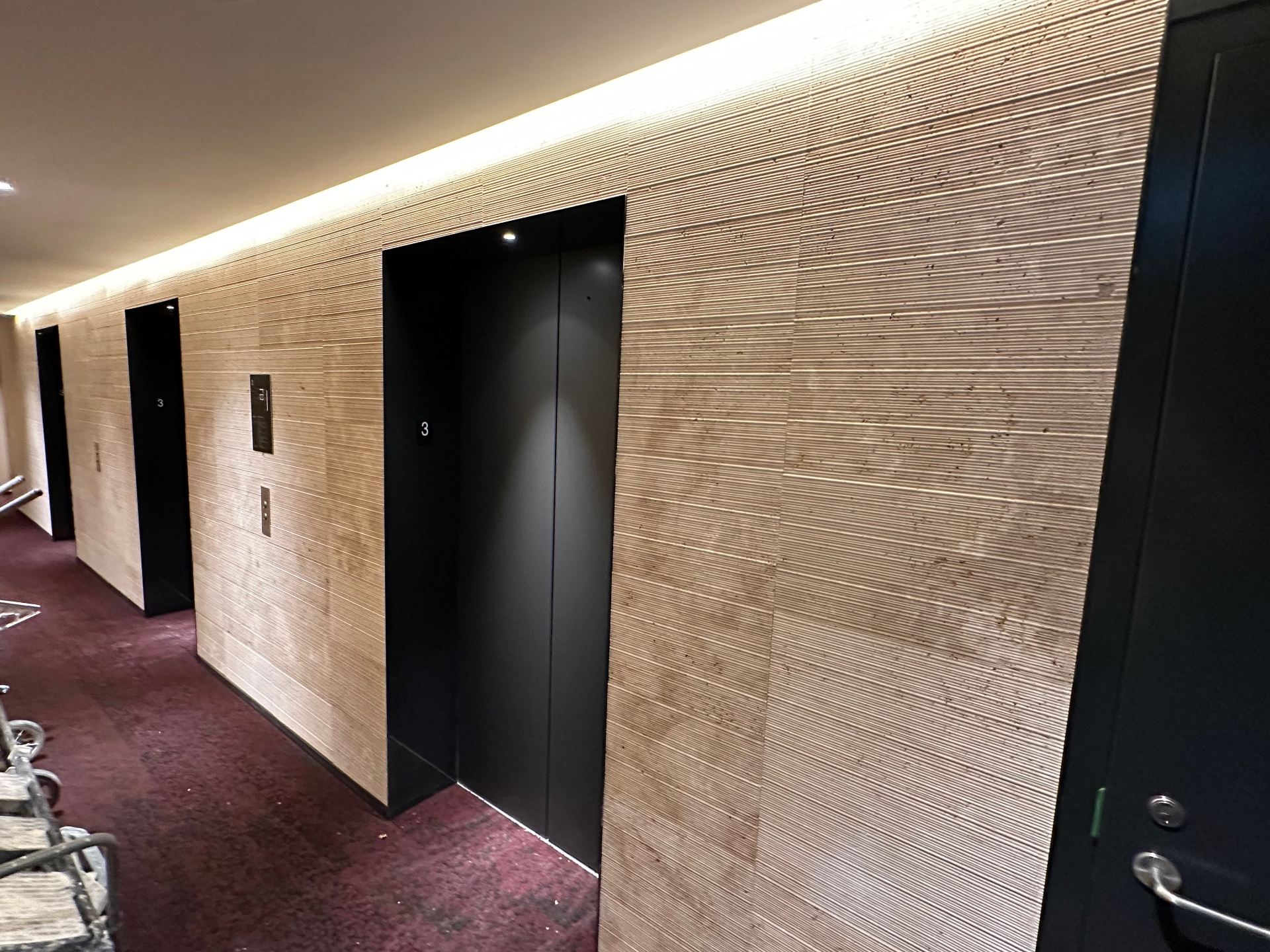 Commercial natural stone wall cladding at elevator lobby