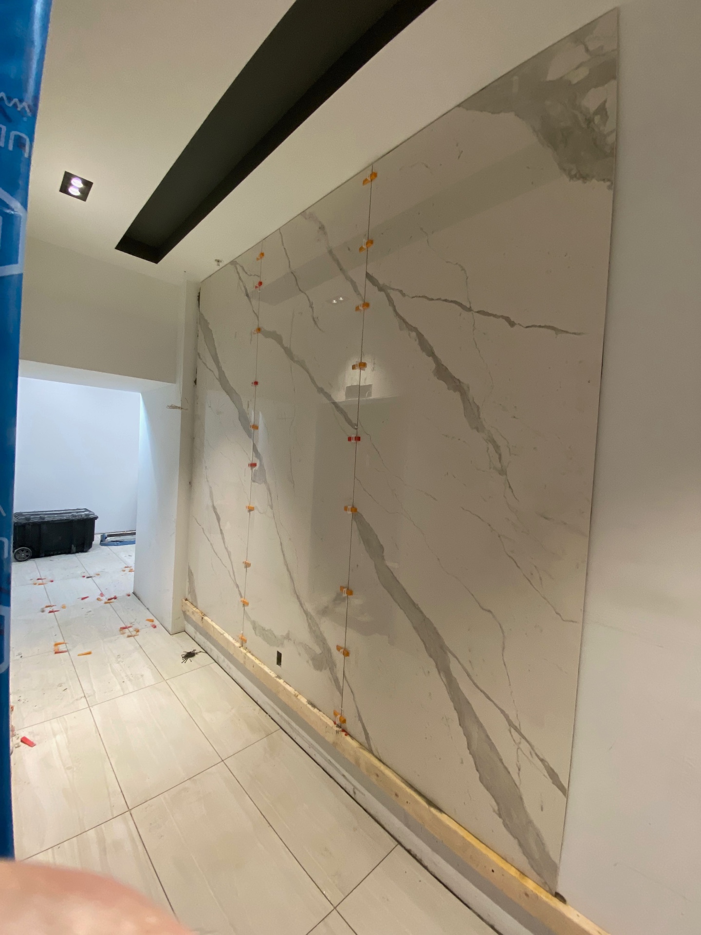 Large-format book-matched marble slab wall installation